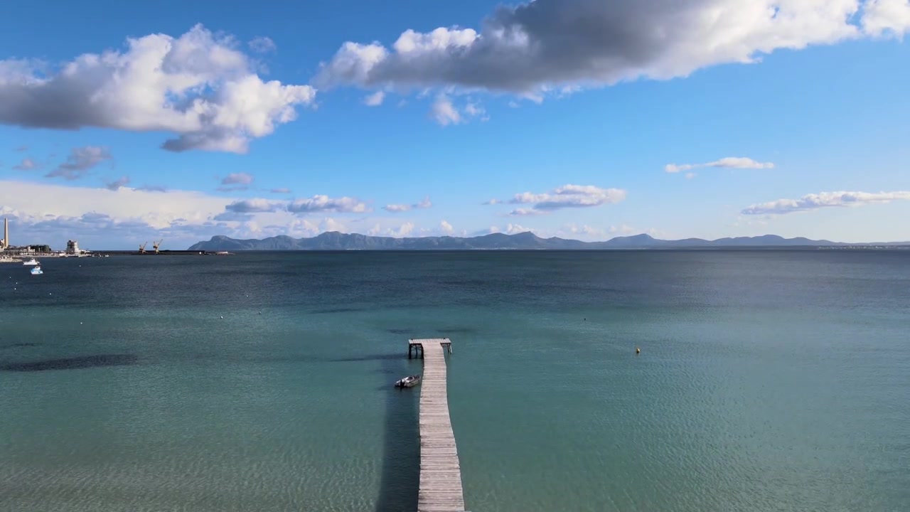 Fast Lift Off from Wooden Pier With Turquoise Blue Sea Water With Mountain Range in the Background
