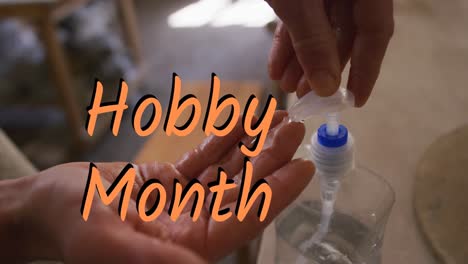 Animation-of-hobby-month-text-over-caucasian-man-disinfecting-hands
