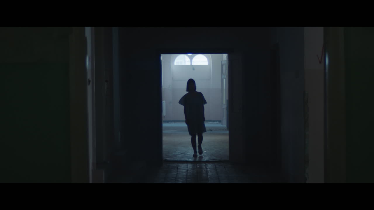 A girl in a dark corridor at night