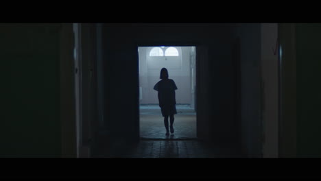 a girl in a dark corridor at night