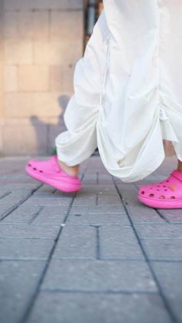 woman in white dress and pink clogs