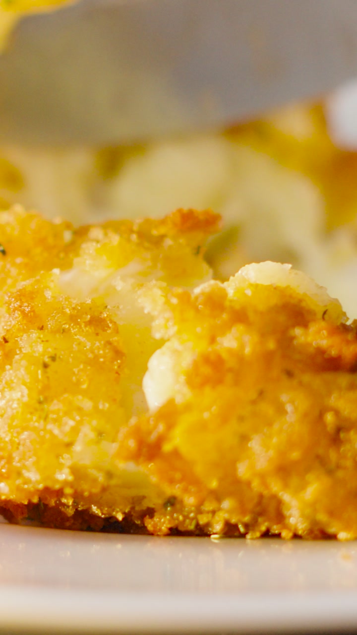 Vertical Video of Knife Cutting into Crispy Delicious Golden Mac and Cheese Croquette In Slow Motion. High Quality Close Up Food Clip.