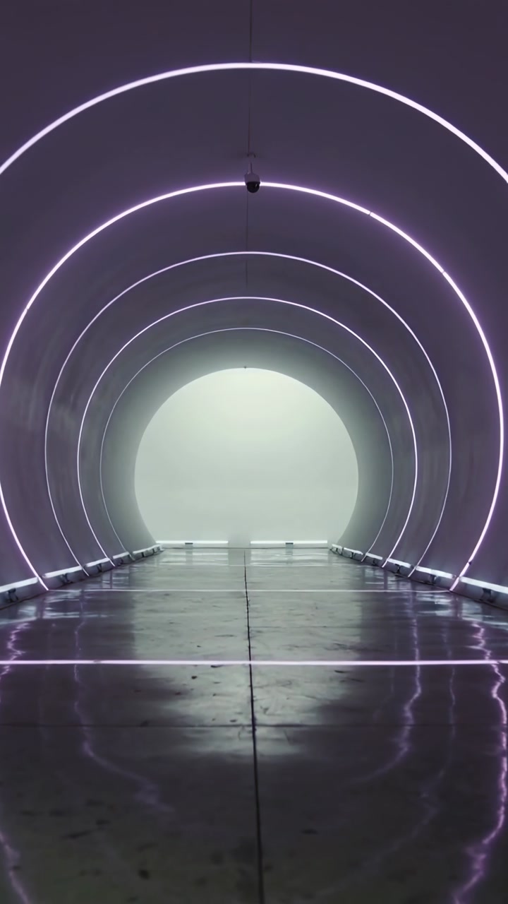 Vertical video: Playing sequence showing curved corridor entrance, LED rings reflecting on floor