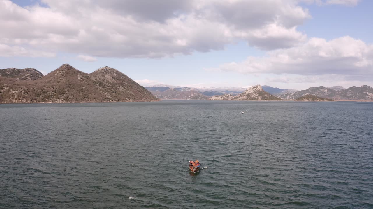 AERIAL - Boat ride on beautiful Lake Skadar, Montenegro, reverse reveal