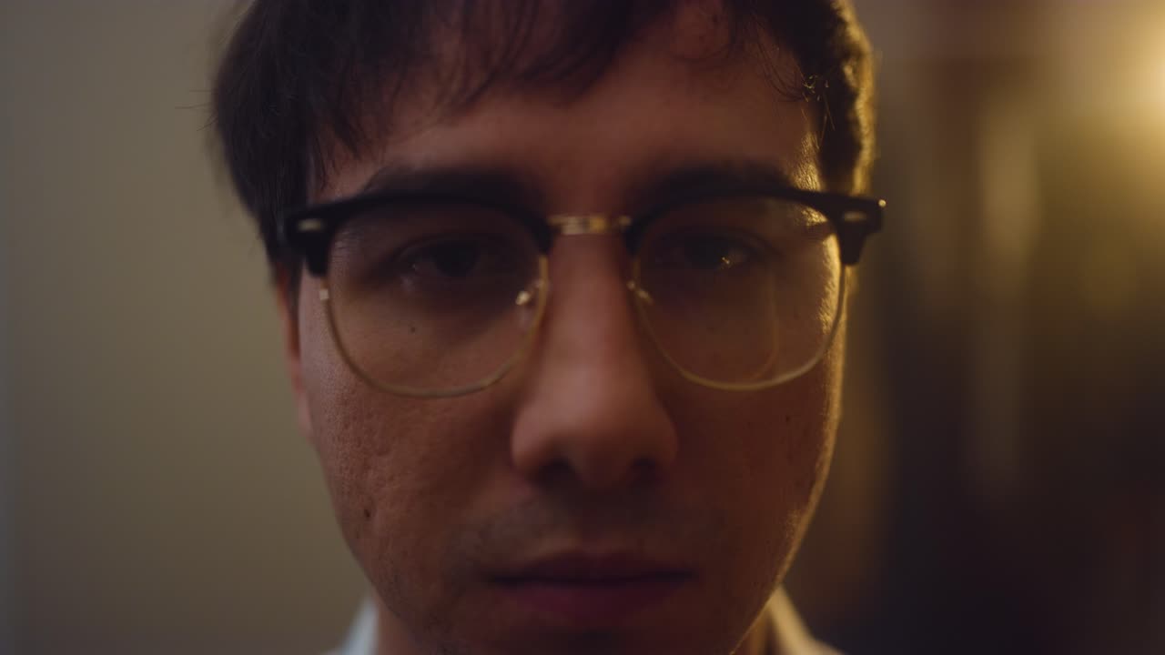 Man looks into camera, upset