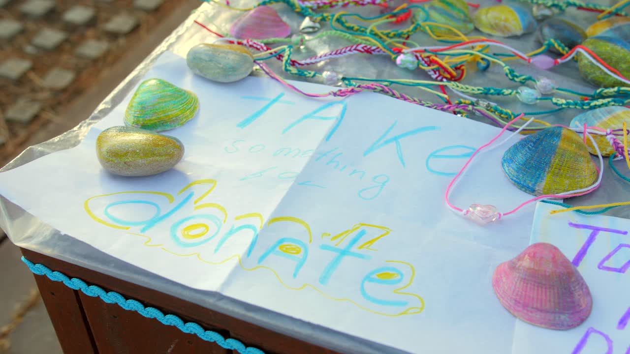 View of donations been raised to support Ukrainian refugees by selling friendship bands and necklaces on the street at daytime