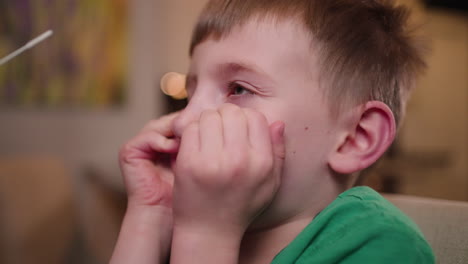 little boy is scared to get a nasal swab for a covid-19 rapid response test