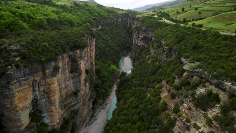 cinematic aerial drone shot of canyons of osumi river in skrapar albania with rocky formations and a natural landscape with a river flowing between the two canyons