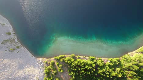 Aerial-Top-Down-Pan-Sideways-Green-Blue-Alpine-Lake-Carnarvon-Lake,-Kananaskis,-Alberta,-Canada