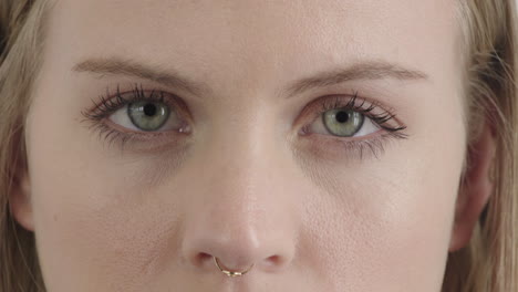 close up face beautiful blonde woman eyes open staring at camera wearing nose ring