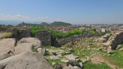 flying over the remains of a rocky terrain near the city of plovdiv in bulgaria