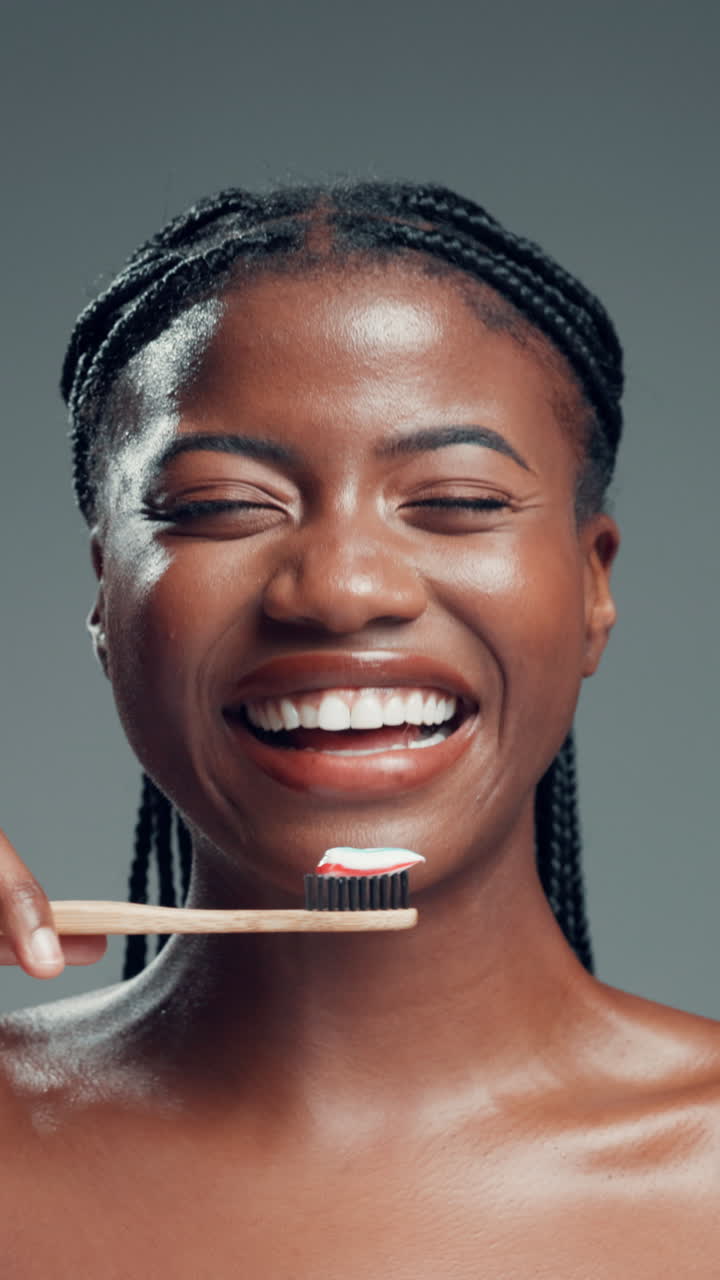 Happy Young Black Woman with Toothbrush and Toothpaste Smiling