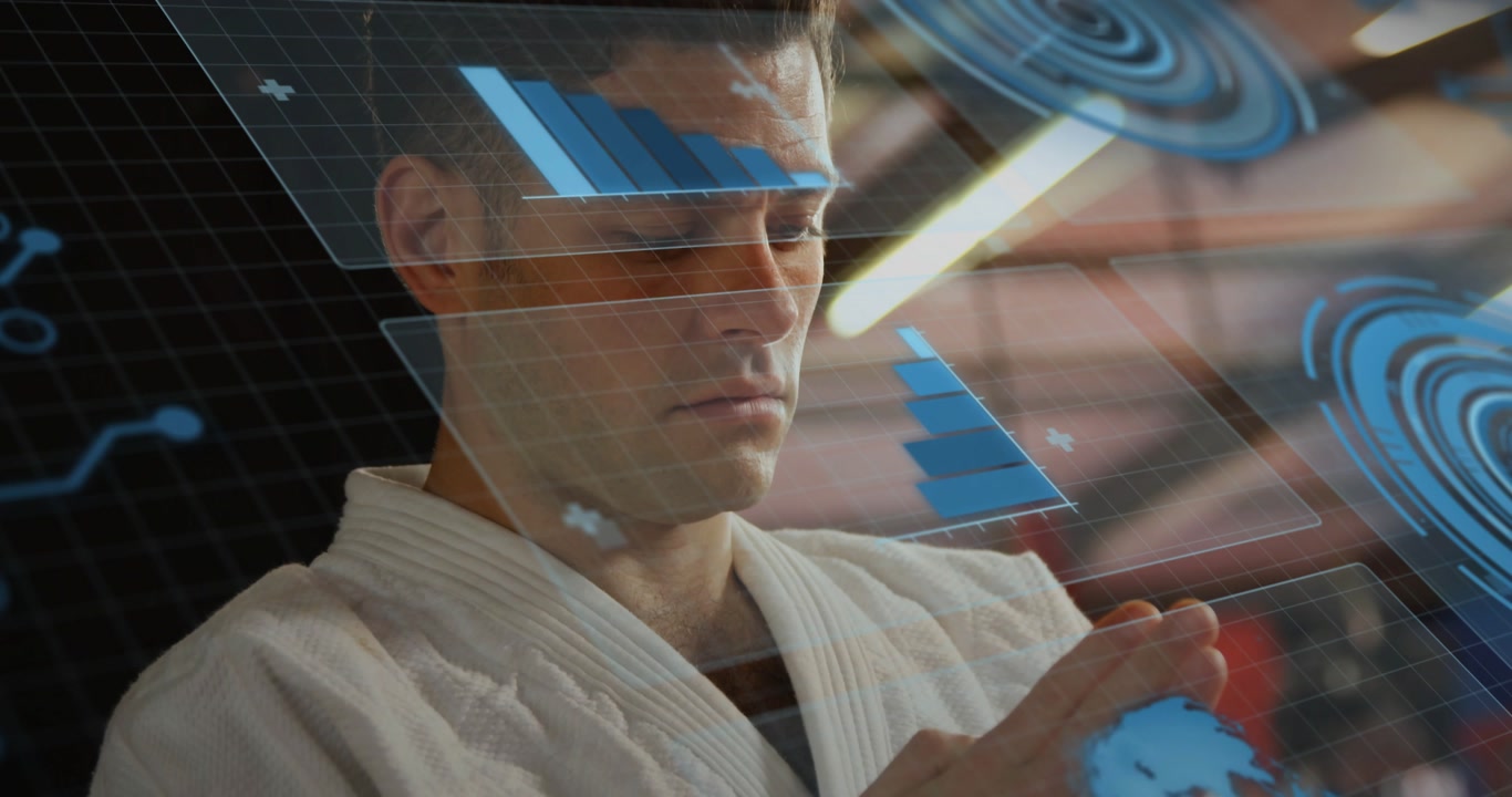 Martial artist lowering hands while faint tech data charts appearing and forming hologram for study