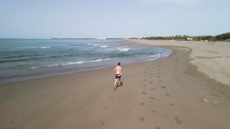 Man-running-on-the-beach-alone