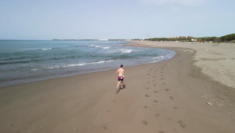 hombre corriendo solo en la playa