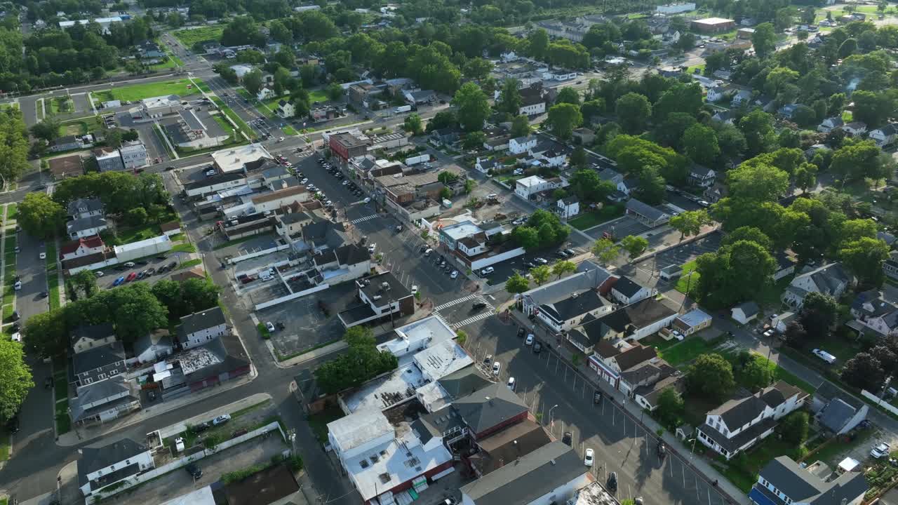 Street of American town with green trees and historic homes in New Jersey. Aerial top down. Serene atmosphere in small neighborhood. Summer season