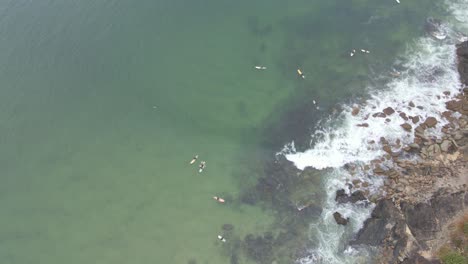 Bird's-Eye-View-Of-The-Surfers-Around-The-Headland-Of-Scotts-Head-In-New-South-Wales,-Australia