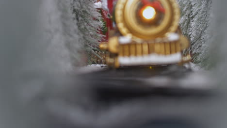 close-up of a toy train passing through a snowy landscape