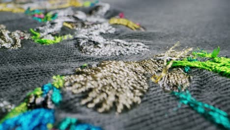 close-up of colorful embroidery on grey fabric