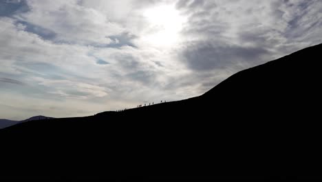 hikers climbing the walking trail to hengifoss waterfall in iceland