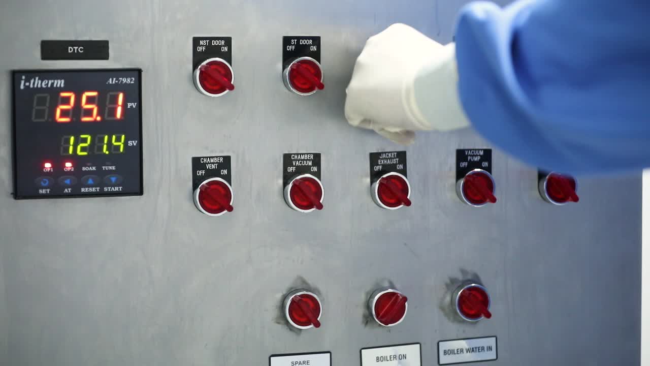 A man switches on and off industrial buttons. Demonstration of industrial buttons.