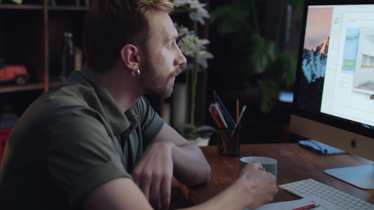 Concentrated creative designer thinking about new interior project at night