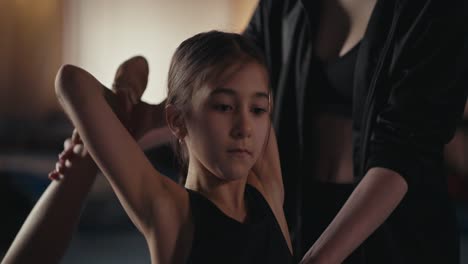 young gymnast training with her coach