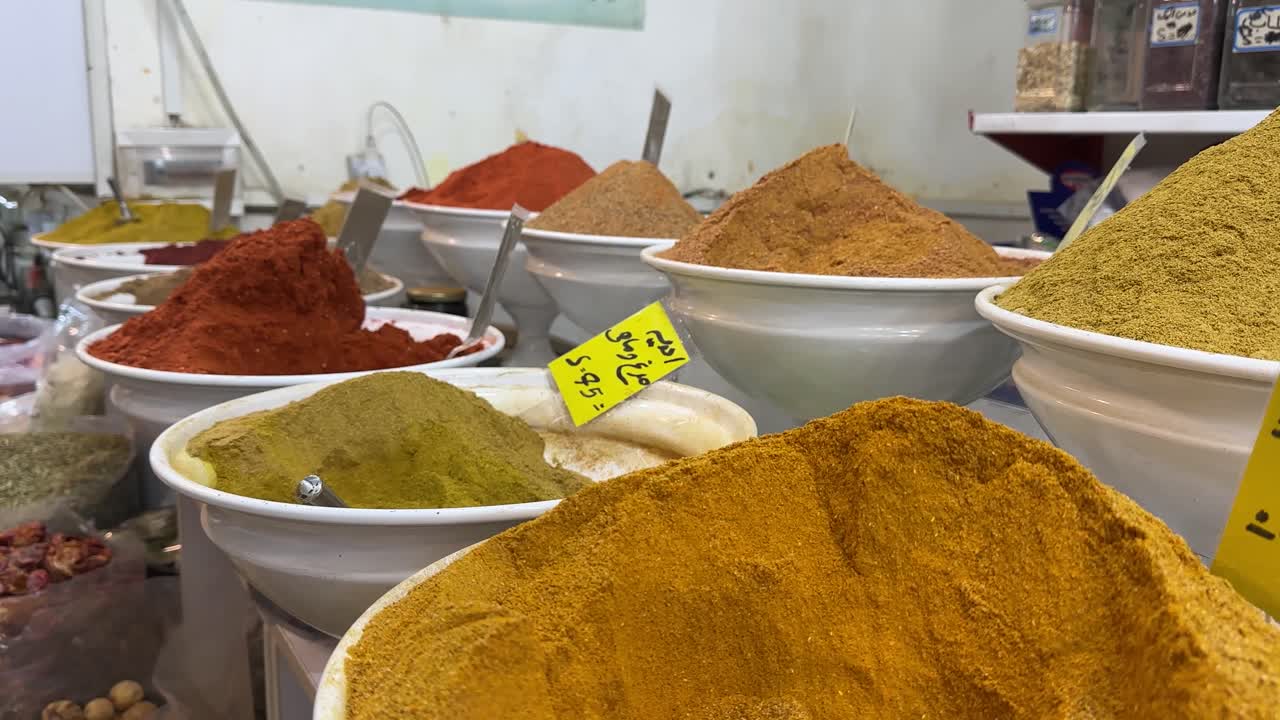 Colorful aromatic spice market in Tehran Iran traditional ingredient saffron cardamom cinnamon chili paprika peppercorns herbs seasoning assortment variety cooking ingredients flavorful dry spices