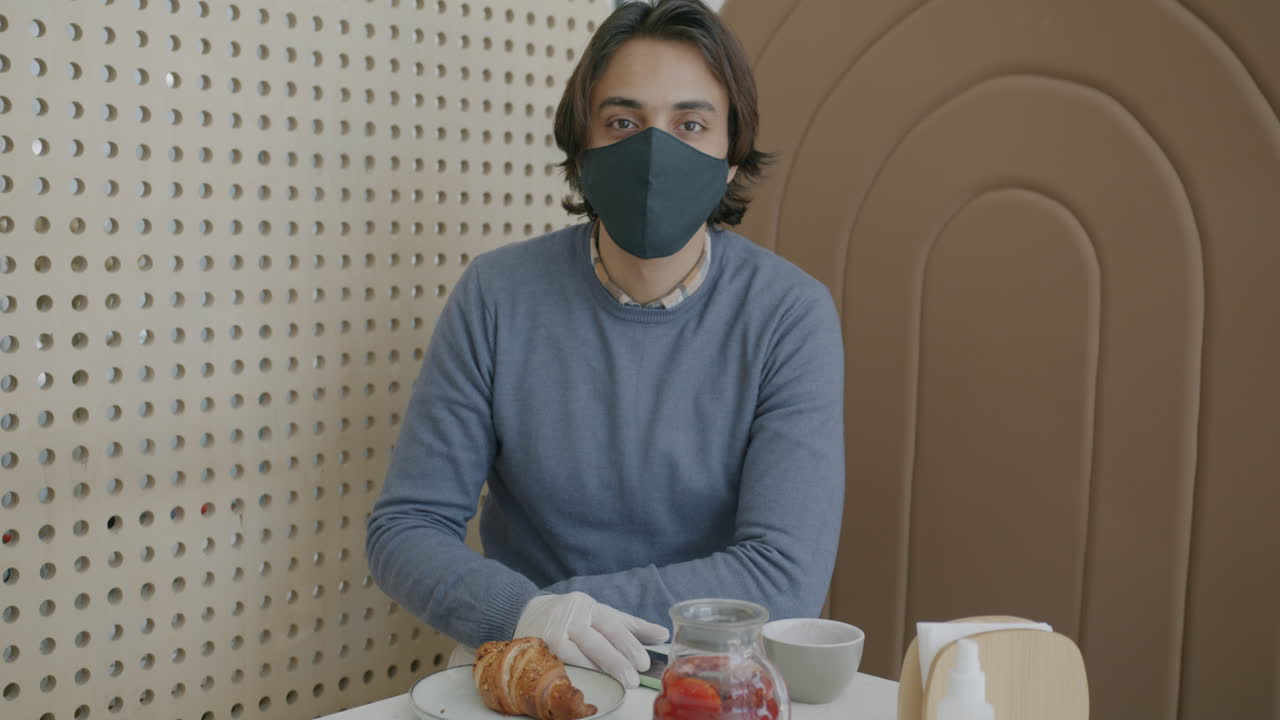 Man in a Cafe with Protective Gear