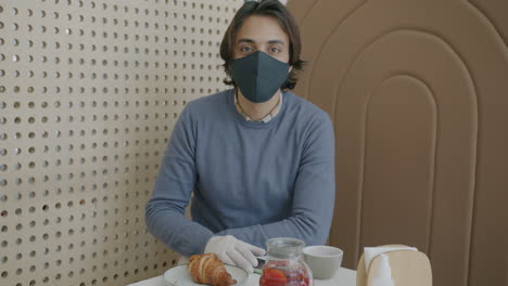 man in a cafe with protective gear