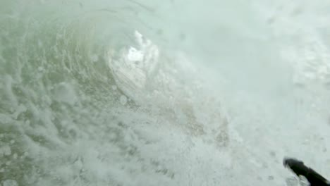 a slow motion point of view shot surfing into a close out wave on the beach