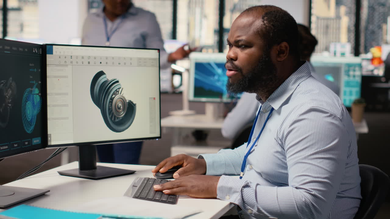 Technician Using Cad Program On Pc To Optimize Wind Turbine Design