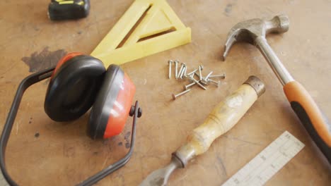 close up of multiple woodworking tools on wooden workshop table in a carpentry shop