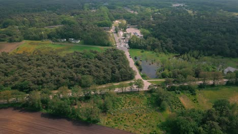 aerial view approaching budel cranendonck asylum center nestled in a dense forest, highlighting its secluded location