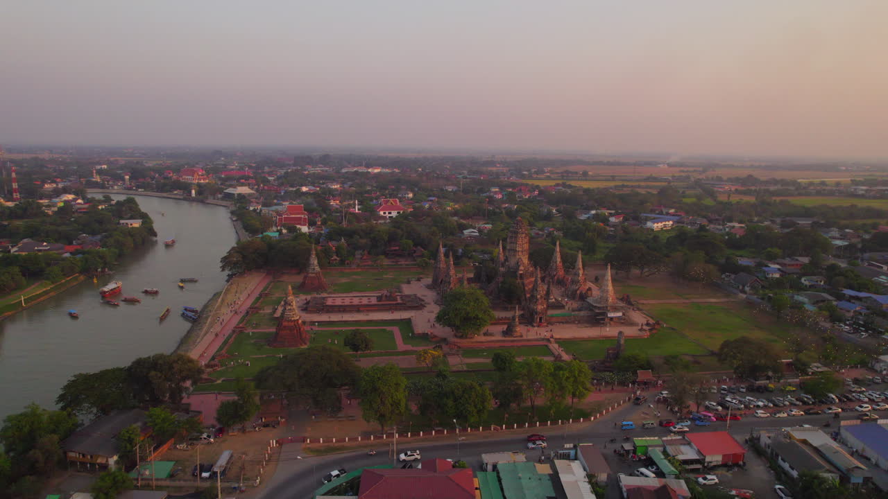 Ilmakuva Wat Chaiwatthanaramin temppelin raunioista ja Chao Phraya -joesta Ayutthayassa, Thaimaassa hämärässä.