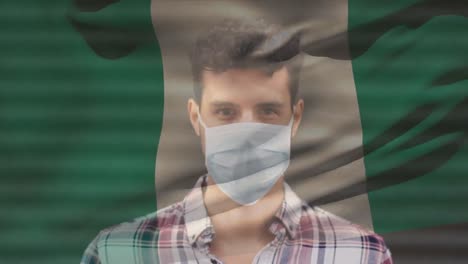 animación de la bandera de nigeria ondeando sobre laitn hombre con máscara facial en la calle de la ciudad