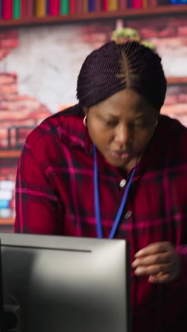 Vertical video Smiling multiethnic technical support team working in call center office