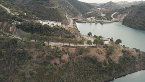 Aerial-view-showing-beautiful-green-hilly-landscape-of-Portugal-and-tranquil-lake-in-Funcho-de-Diante