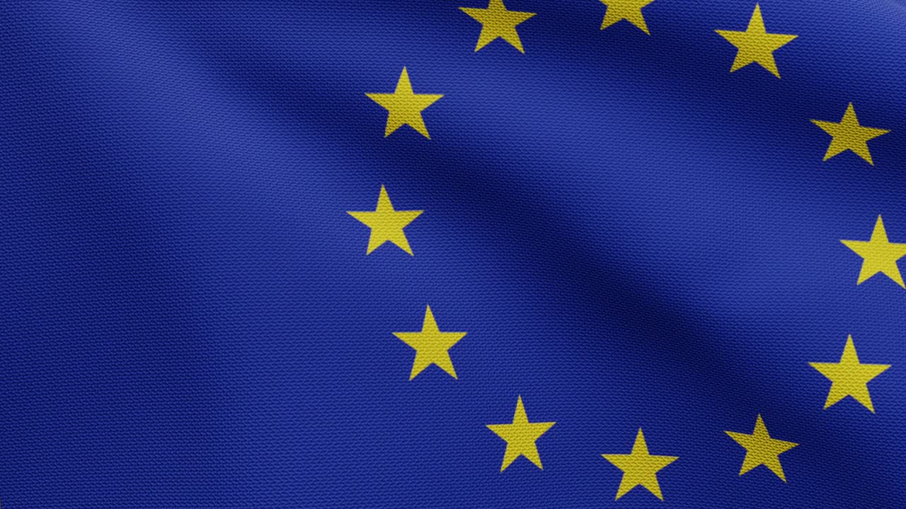 European Union flag waving in the wind. Close up Europe banner silk blowing
