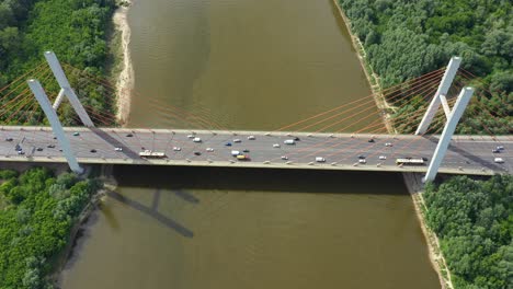 Aerial-or-top-view-from-drone-of-concrete-bridge-with-asphalt-road-or-highway-over-big-river-with-city-car-traffic,-urban-transportation,-toned