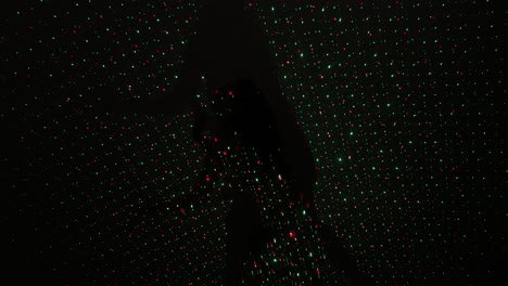 abstract female dance performance in a dark laser lit room