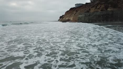 View-from-a-drone-flying-over-the-coast-on-a-cloudy-day