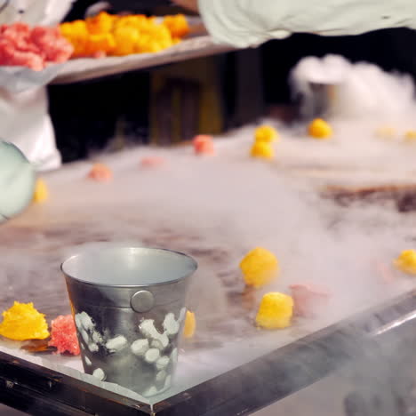 chef preparing a plated dessert with dry ice smoke