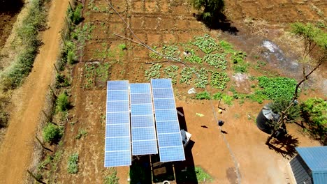 Aerial-drone-view-into-large-solar-panels-at-a-solar-farm-at-bright-sunset