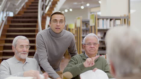 senior people having debate during class in library