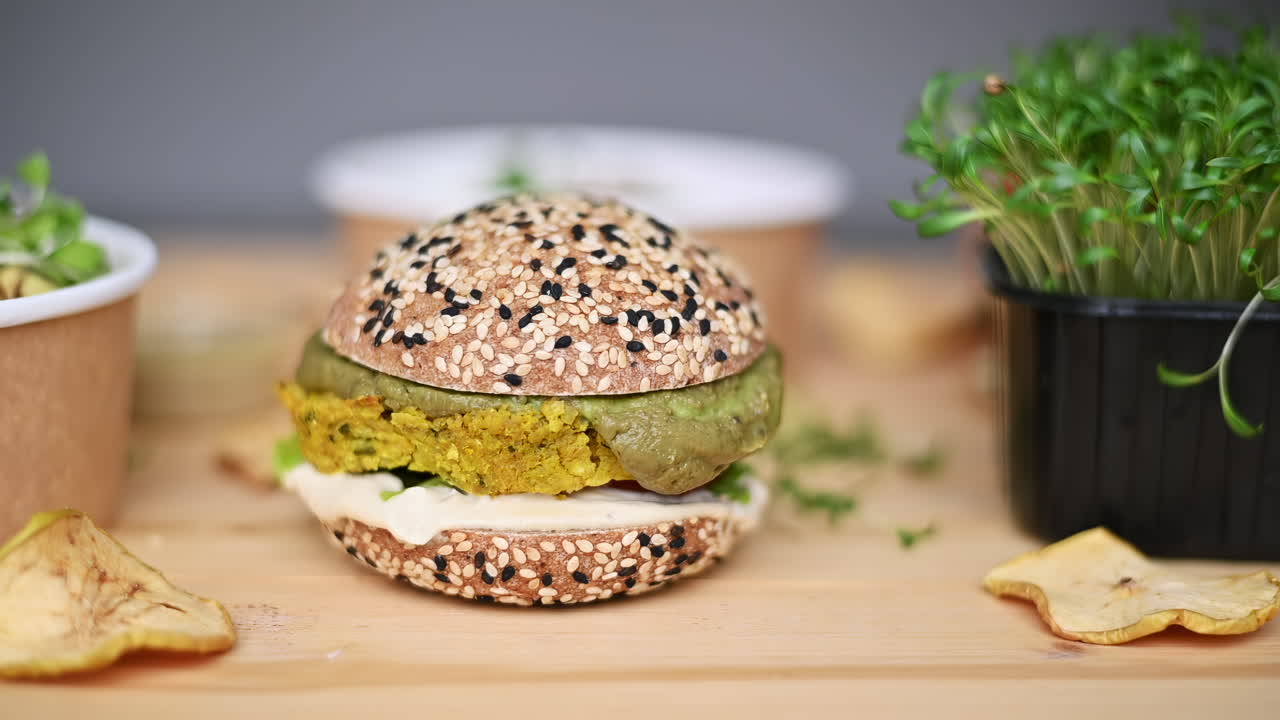 This clip features a vibrant plant-based burger served on a sesame seed bun alongside fresh sprouts. The setting is bright and inviting, perfect for healthy eating