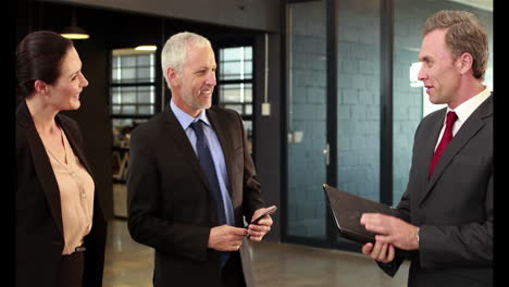 Business-people-handshaking-and-looking-at-documents