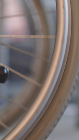 legs of young nurse pushing wheelchair with large wheels in hospital. woman takes care of patient with disability helping to move closeup