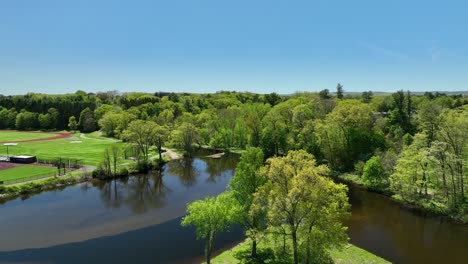 mill river and paradise pond at smith college on beautiful spring day, northampton