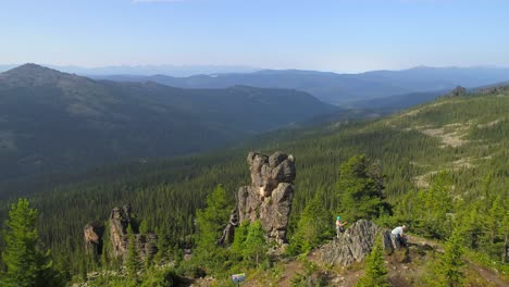 aerial view of a mountain range with people hiking